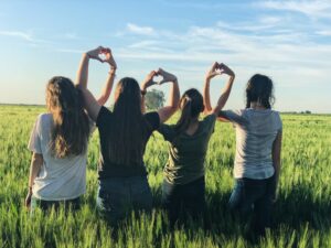 Forsis network. thanks to unsplash: four ladys holding their hands up forming heart shapes with their fingers