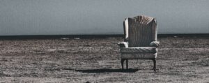 the old armchair (an old worn armchair standing on a beach)
