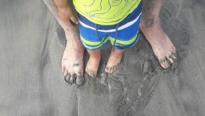 little feet between big feet learning to walk